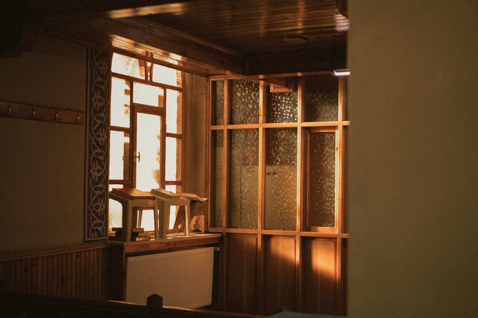 Sunlit room with traditional wooden interior design featuring a cozy, serene atmosphere