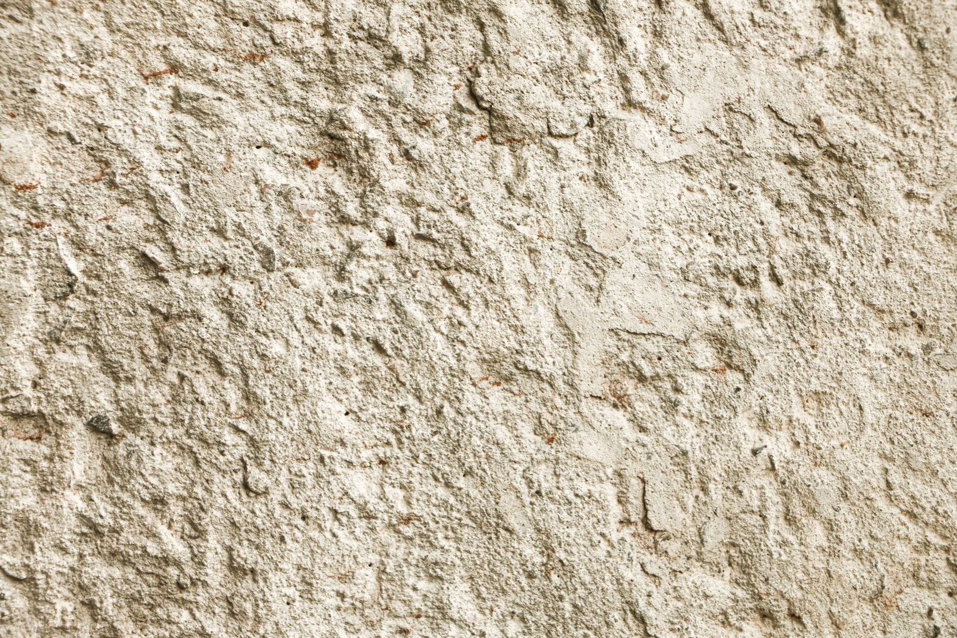 Close-up texture of a rough stone wall surface in natural light